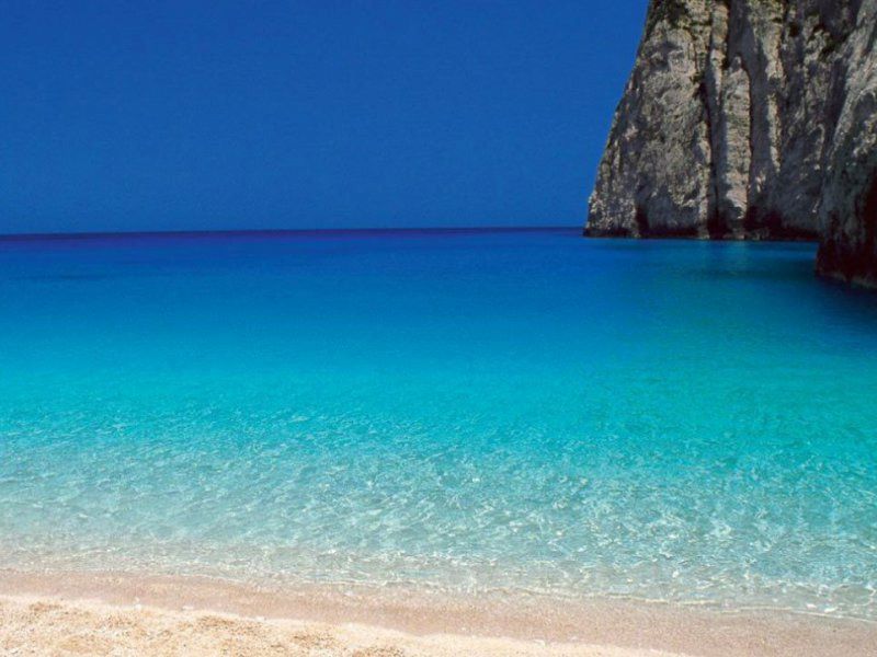 blue sandy beach in dassia corfu